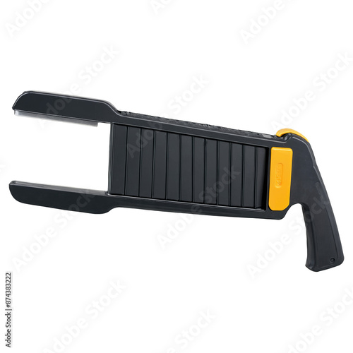 A rectangular handheld object made of metal and plastic. On one side there is a textured handle for grip while on the other side there is a circular metal piece with ridges..