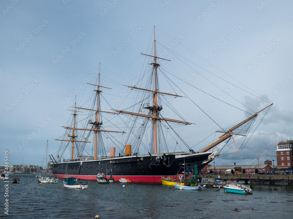 Portsmouth England - May 3 2024: HMS Warrior 1860 a 40 gun steam powered armoured frigate in Portsmouth Harbour Hampshire England Portsmouth England - May 3 2024: HMS Warrior 1860 a 40 gun steam powered armoured frigate in Portsmouth Harbour Hampshire England
