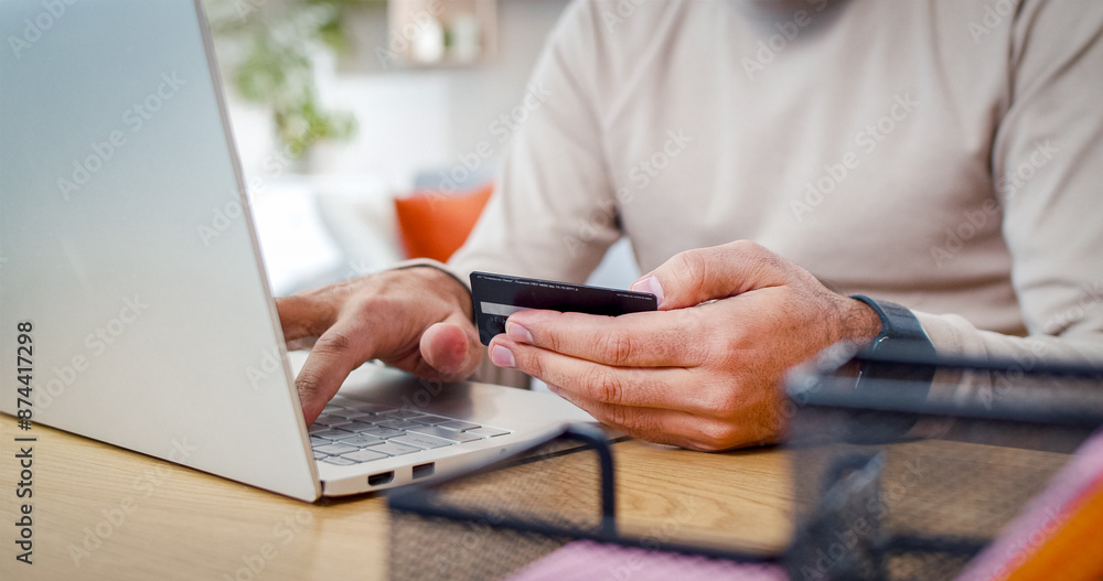 Close up portrait of man's hands clicks on keys of laptop dialing number of bank card. Person going to make purchases online. Close up portrait of man's hands clicks on keys of laptop dialing number of bank card. Person going to make purchases online.