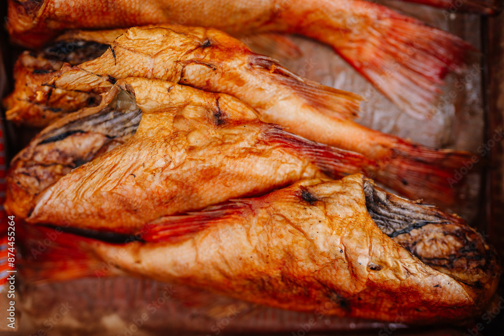 limbazi, Latvia, June 29, 2024 - Close-up of smoked fish, with golden-brown skin and visible texture. The fish are arranged on a surface, ready to be eaten. limbazi, Latvia, June 29, 2024 - Close-up of smoked fish, with golden-brown skin and visible texture. The fish are arranged on a surface, ready to be eaten.