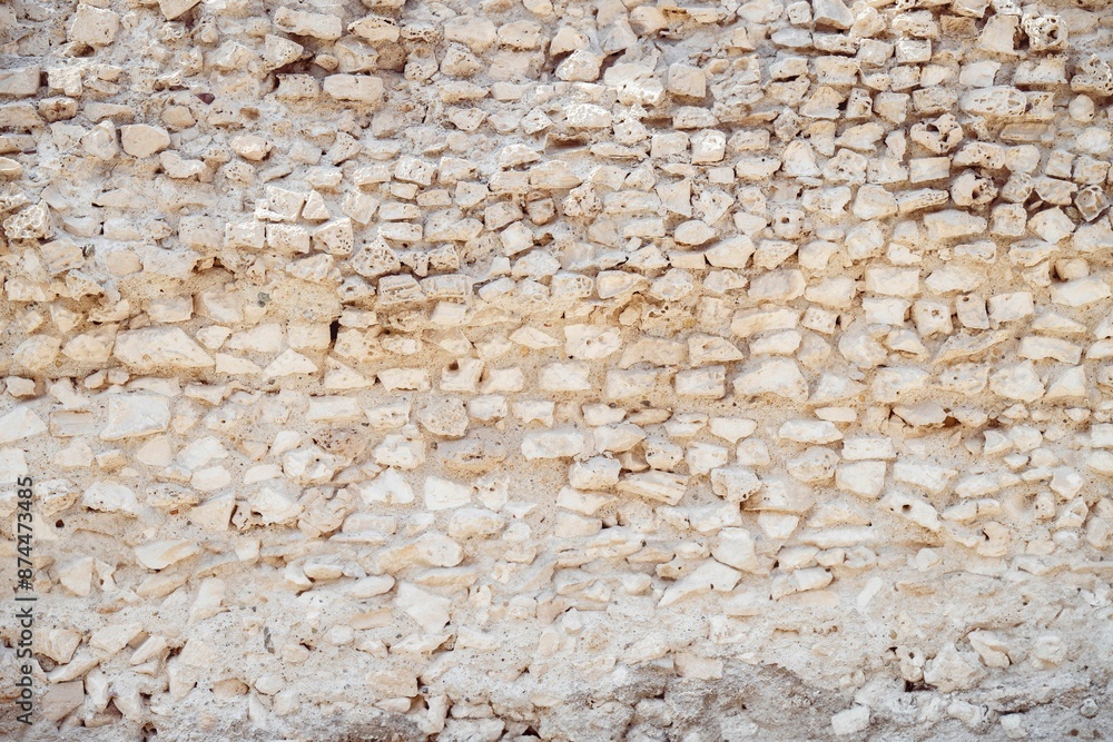 Ancient stone wall with irregularly shaped rocks and a rough texture. Ancient stone wall with irregularly shaped rocks and a rough texture.