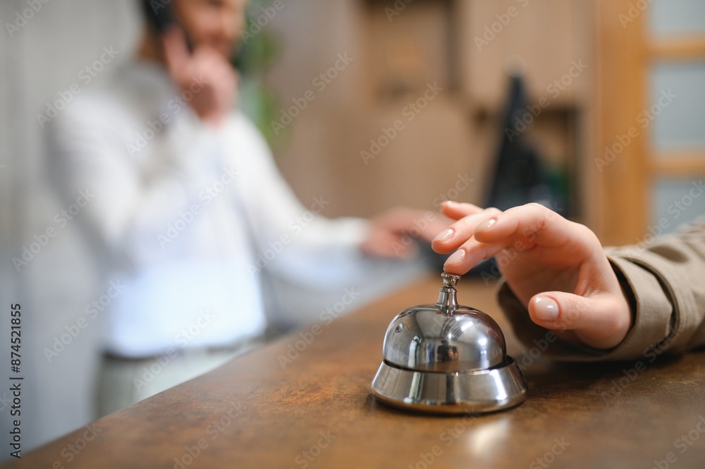 Hand of a woman using a hotel bell Hand of a woman using a hotel bell