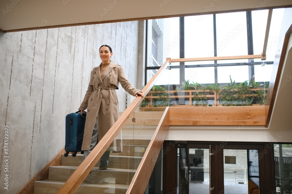 Beautiful businesswoman on stairs in modern hotel Beautiful businesswoman on stairs in modern hotel