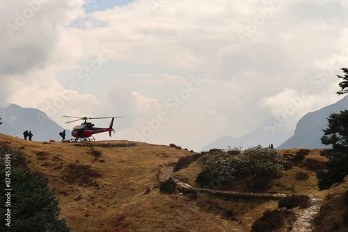 Bild auf Leinwand A helicopter is about to take off from the heliport close to the Mount Everest v