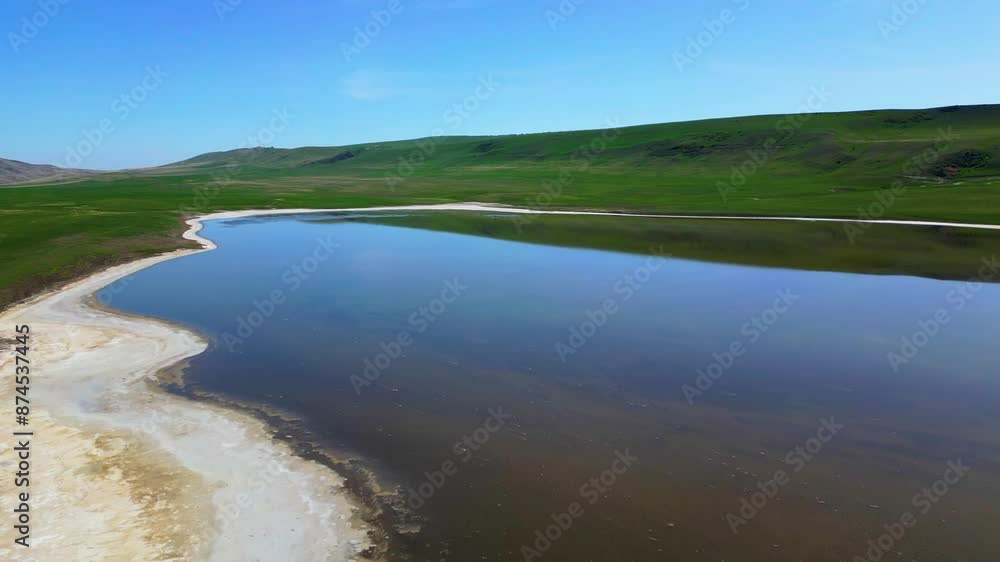 Mountain landscape with blue sky, clouds, green hills, blue mountain salt lake, taken from a height Mountain landscape with blue sky, clouds, green hills, blue mountain salt lake, taken from a height