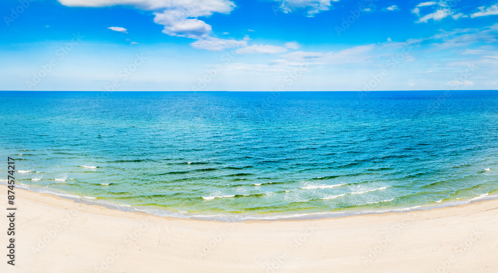 Fototapeta premium panoramic drone view of waves crashing on beach