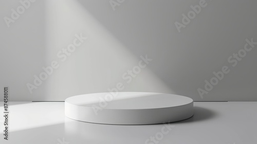 Minimalist podium with a round base and a smooth white surface, set against a light gray background, suitable for product displays