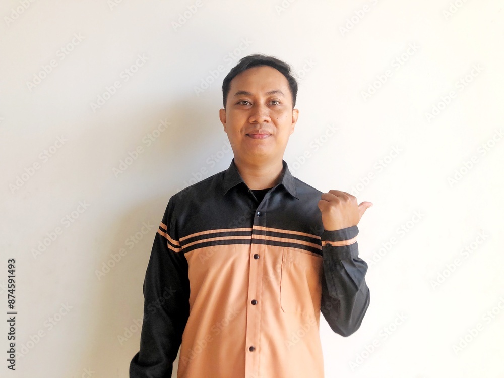 Asian man smiling happily at the camera and giving a thumbs up