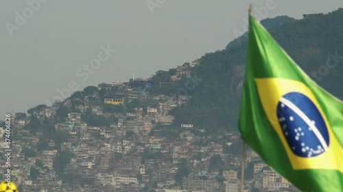 Brazilian Flag Waving in Ipanema Beach in front of Vidigal Favela