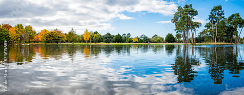 lake reflection on the park in autumn season.