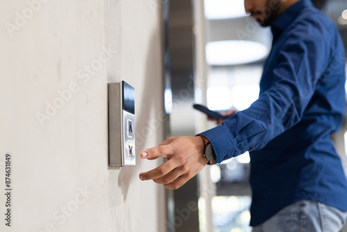 Using keycard, man accessing secure entry system of office building