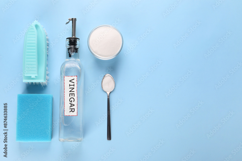 Eco friendly natural cleaners. Flat lay composition with bottle of vinegar on light blue background, space for text Eco friendly natural cleaners. Flat lay composition with bottle of vinegar on light blue background, space for text