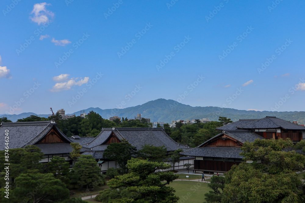 Background landscape of the beauty of Nijo Castle in Kyoto with a clear sky and mountains and trees in summer. nuances of ancient Japanese architecture Background landscape of the beauty of Nijo Castle in Kyoto with a clear sky and mountains and trees in summer. nuances of ancient Japanese architecture