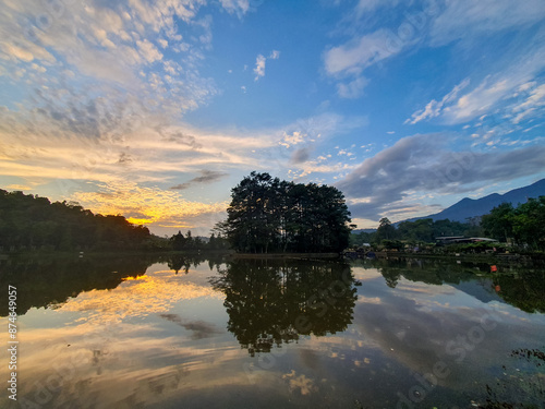 Beautiful sunrise with sky reflection of situ Wanayasa. One of spot tourism destination of Purwakarta West Java Indonesia.  photo