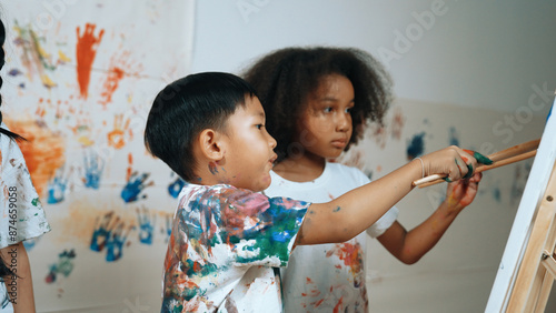 Photography Happy creative african girl painted or draw canvas together with asian boy