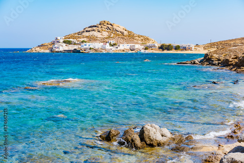 Fototapeta Naklejka Na Ścianę i Meble -  Paraside Beach in Mykonos, Greece, umbrella and luxury beach chairs beds in front of blue ocean. Most famous beach with crystal water and beach music bars. Gimbal cinematic ProRes graded from Log