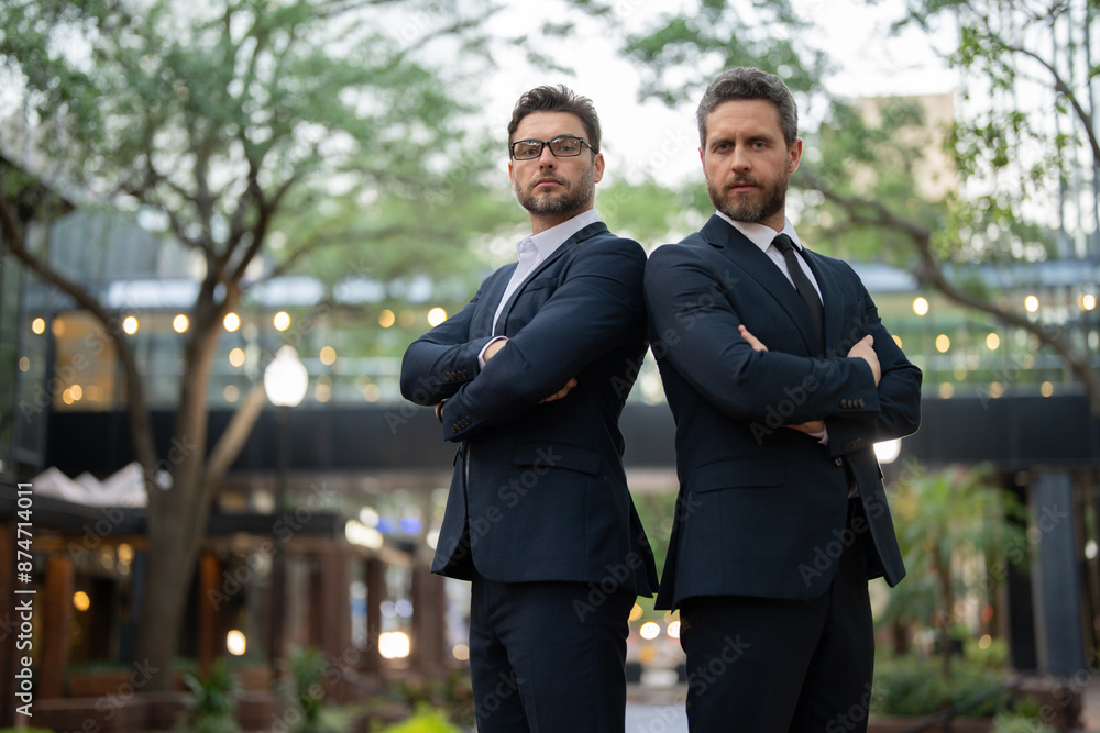 businessmans in casual attire looking at camera. two businessmen in suits with their arms crossed looking at the camera. sstkBusiness. two successful businessmen in suits with their arms crossed businessmans in casual attire looking at camera. two businessmen in suits with their arms crossed looking at the camera. sstkBusiness. two successful businessmen in suits with their arms crossed