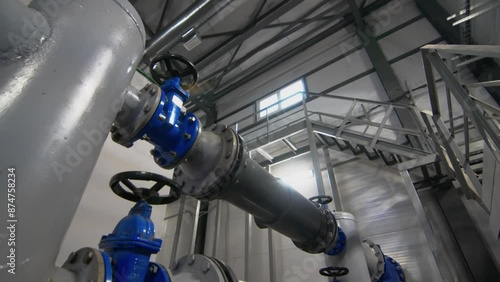 Pipework with valves to supply wastewater to tanks. Water head control system in workshop. Organization of equipment operation process photo