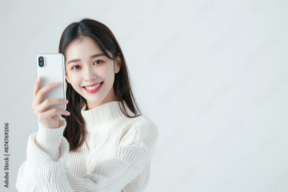 Woman taking a selfie with a green smartphone isolated on a white background. Woman taking a selfie with a green smartphone isolated on a white background.