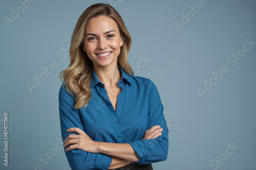 Portrait of smiling young woman confidently with long blonde hair in blue shirt