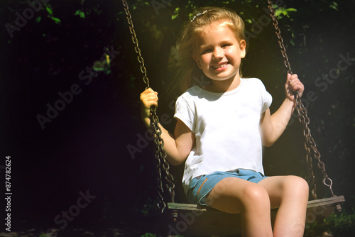 Happy child girl on swing, summer time. Life Events. Retro toned, Soft focus effect