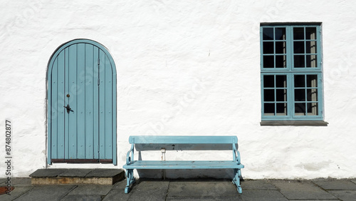  white wall with pastel blue door and window in Oslo, Norway