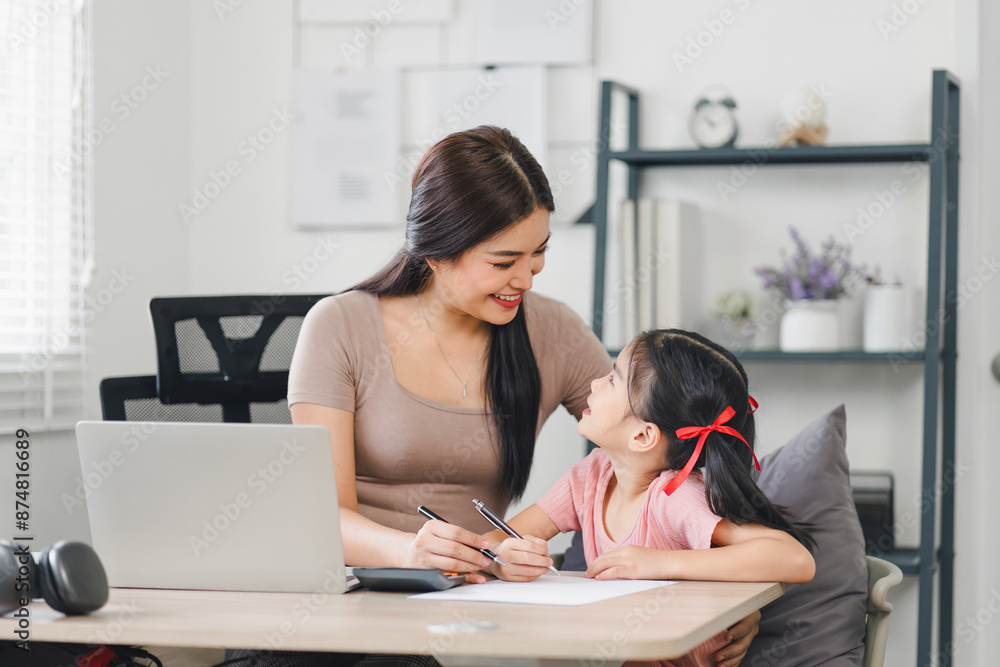mother teaching daughter and helping her with homework at home. education, family and homework concept mother teaching daughter and helping her with homework at home. education, family and homework concept