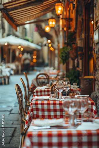 Fototapeta Naklejka Na Ścianę i Meble -  Empty restaurant tables waiting for customers in italian city