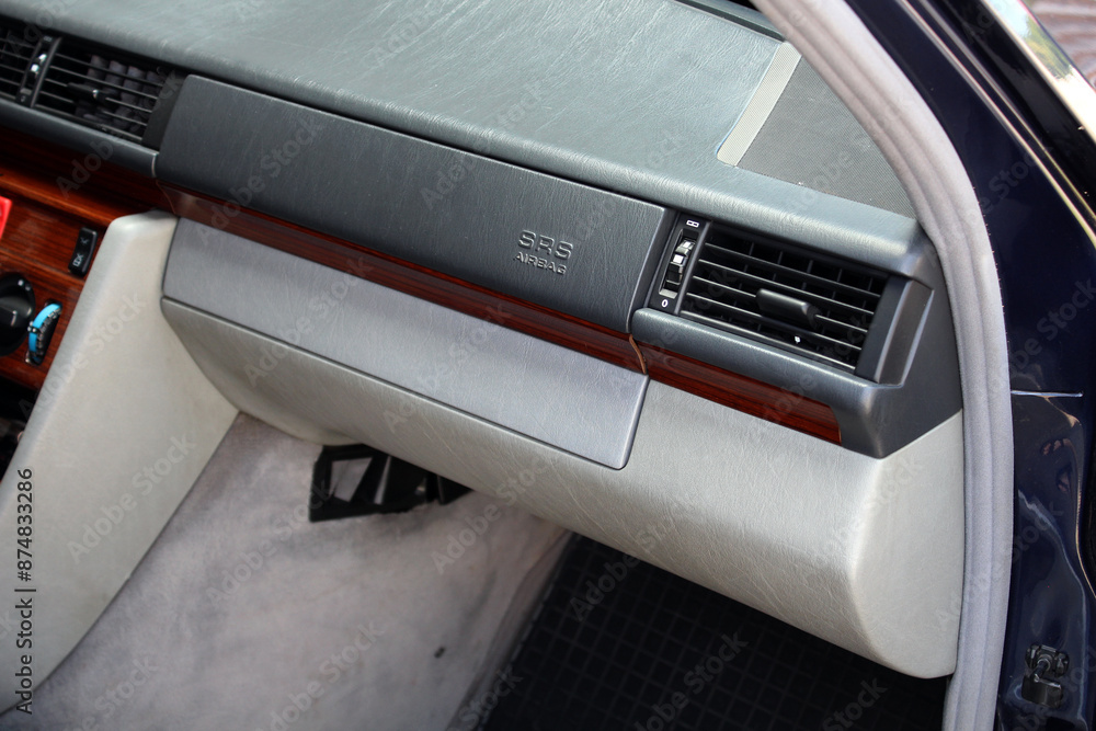 Old classic car glove box. Old Car air conditioner, wood interior of classic vehicle. Old car Passenger airbag. Front airbag. Air ventilation grille with power regulator. Old classic car glove box. Old Car air conditioner, wood interior of classic vehicle. Old car Passenger airbag. Front airbag. Air ventilation grille with power regulator.