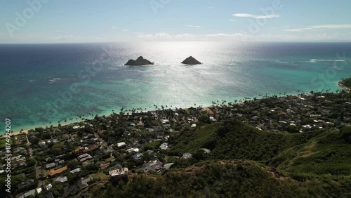 Aerial drone video over Lanakai Pillbox of Kailua Bay and Na Mokolua off the windward coast of Oahu