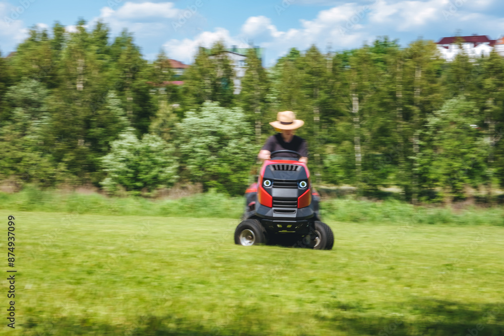 Man on lawn tractor mowing lawn on backyard. The red rider. The lawnmower tractor. High quality 4k footage Man on lawn tractor mowing lawn on backyard. The red rider. The lawnmower tractor. High quality 4k footage