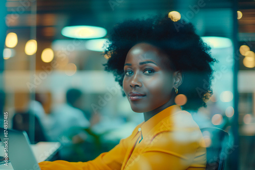 Portrait executive african female manager looking at camera in office with blurred people background