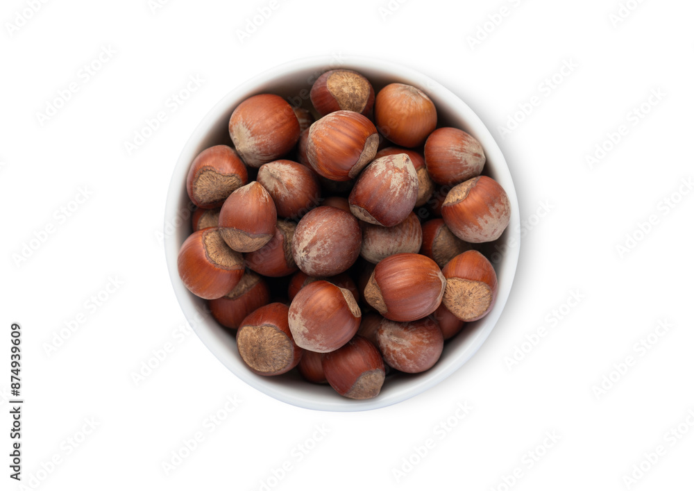 Ceramic bowl with healthy hazelnut nuts with shell isolated on white background.Top view. Ceramic bowl with healthy hazelnut nuts with shell isolated on white background.Top view.