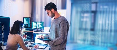 asian and Indian Developer team discussion feedback analysis coding data with software computer at office