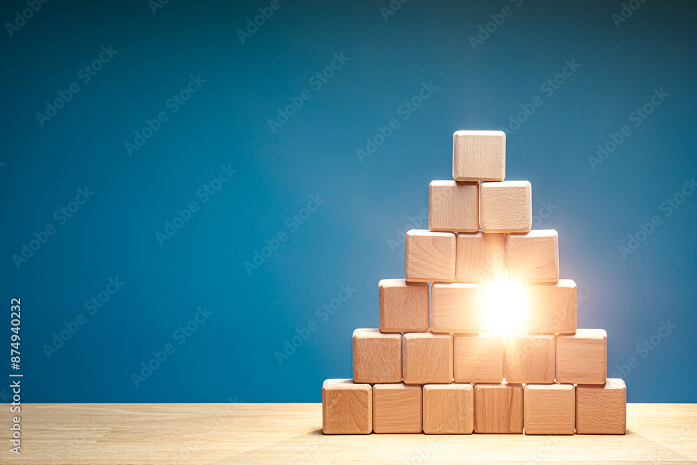 A wooden block pyramid with a single block missing, and a bright light shines through the gap. Vacant place in the team concept A wooden block pyramid with a single block missing, and a bright light shines through the gap. Vacant place in the team concept