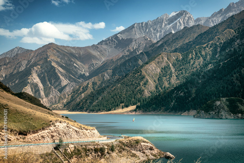 Gorgeous landscape view of Kuche Dalongchi with a sailboat sailing in the lake photo