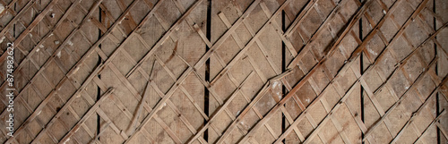 Mesh of slats for plastering the walls of a house. Fragment of the cladding of a wooden wall of an old house. The plaster had fallen off and exposed the wooden planks of the wall.