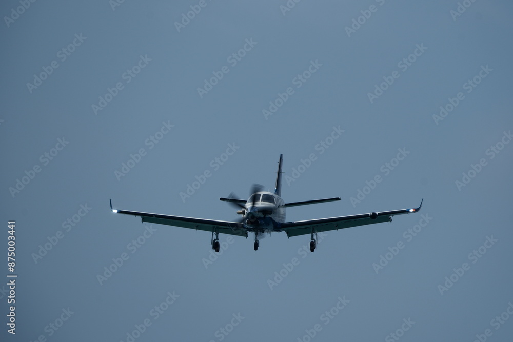 Single-engined turboprop airplane in the cloudy sky. Single-engined turboprop airplane in the cloudy sky.