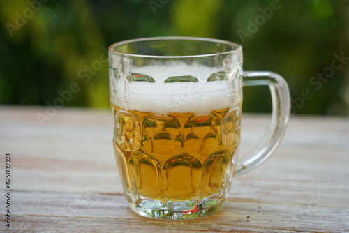 Beer mug on the table with beer. Pilsner lager golden beer