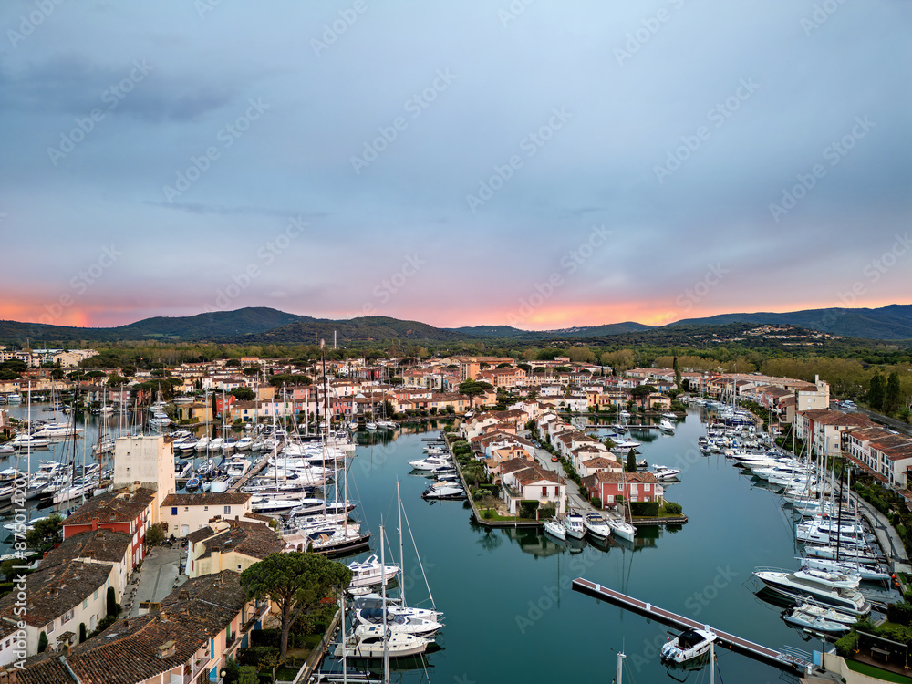 Port Grimaud, marina in France with yachts and sailboats with evening sun and sunset Port Grimaud, marina in France with yachts and sailboats with evening sun and sunset