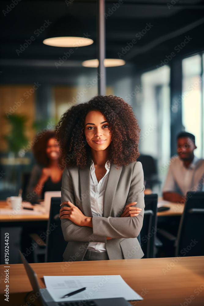 This image portrays a confident businesswoman in a modern office, leading a group of colleagues. Her professional demeanor and smile convey leadership and success in a corporate environment. This image portrays a confident businesswoman in a modern office, leading a group of colleagues. Her professional demeanor and smile convey leadership and success in a corporate environment.