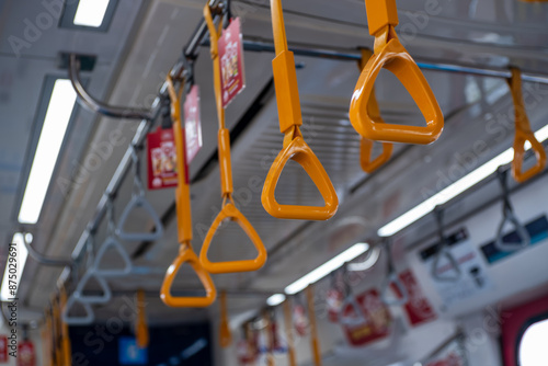 Closeup of yellow hand grip on the Jakarta Mass Rapit Train photo