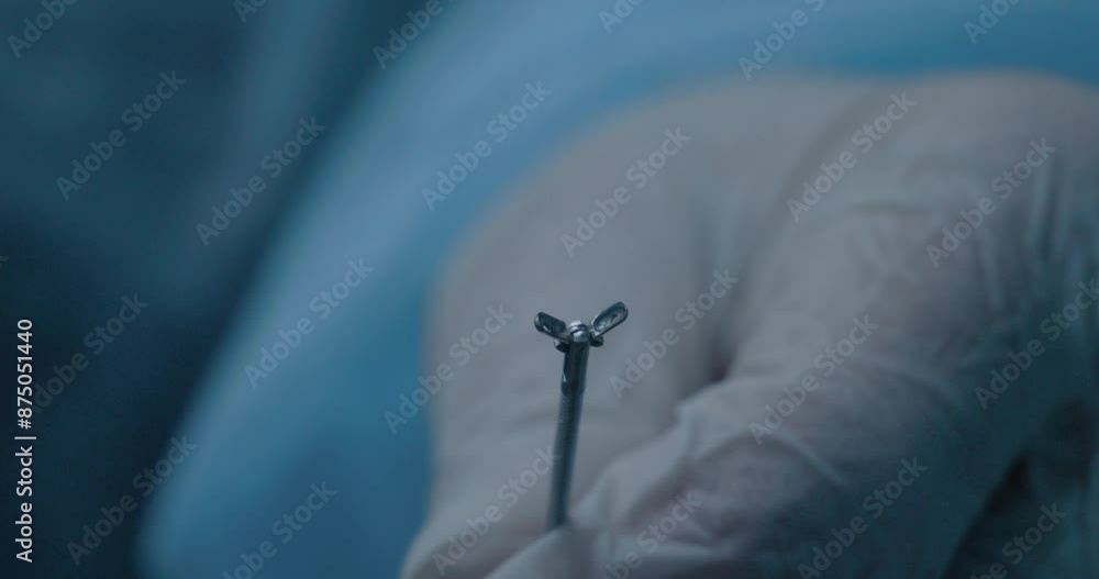 Forceps Body Close-up of a surgeon's gloved hands holding endoscopic biopsy forceps ...