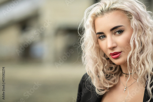 Portrait of a young beautiful blonde girl outdoors.