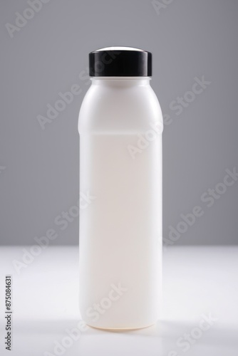  a white plastic bottle with a black lid on a white surface with a gray background, © Tisha