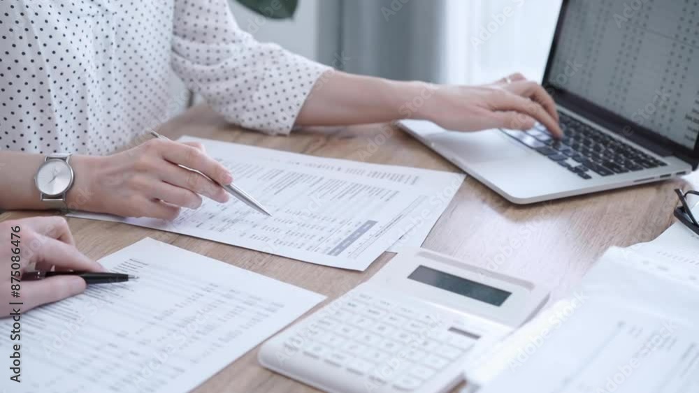 Professional female bookkeeper with a colleague are working on business finances. using calculator and laptop. Finance audit and taxes Professional female bookkeeper with a colleague are working on business finances. using calculator and laptop. Finance audit and taxes