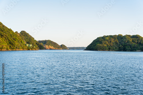 Dramatic rock formations covered with lush greenery on the coast of Pacific Ocean in Nachikatsuura, Wakayama, Japan, part of the Yoshino-Kumano National Park. photo