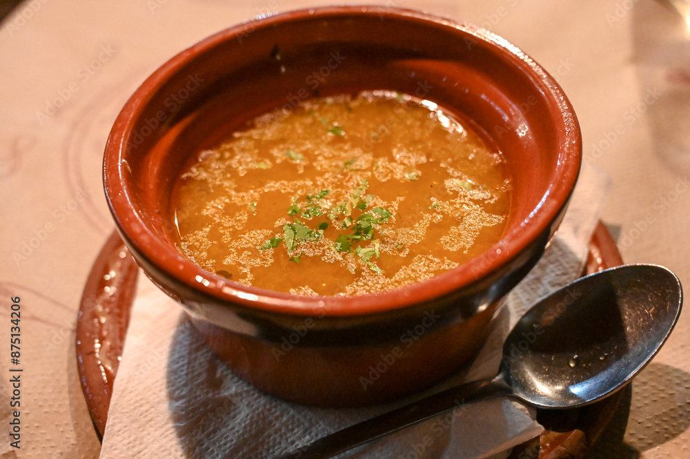 Soup served in a bowl in a restaurant. Soup with noodles and veal. Soup served in a bowl in a restaurant. Soup with noodles and veal.