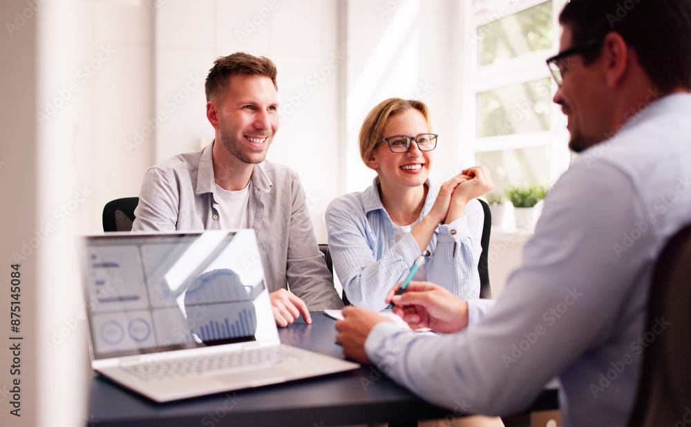 Young couple discussing their financial future with a Hispanic financial planner