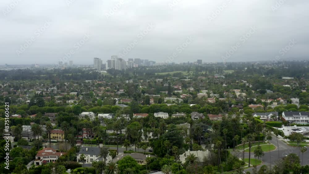 Aerial Panning Beautiful Shot Of Buildings On Green Landscape In Residential City Under Cloudy Sky - Beverly Hills, California Aerial Panning Beautiful Shot Of Buildings On Green Landscape In Residential City Under Cloudy Sky - Beverly Hills, California